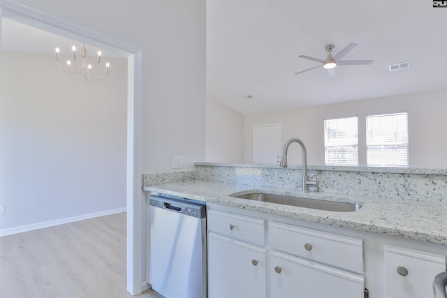 kitchen featuring light stone counters, a ceiling fan, visible vents, a sink, and stainless steel dishwasher