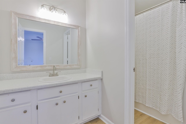 bathroom featuring vanity and curtained shower