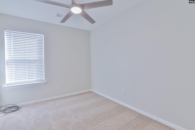 unfurnished room featuring baseboards, plenty of natural light, a ceiling fan, and carpet