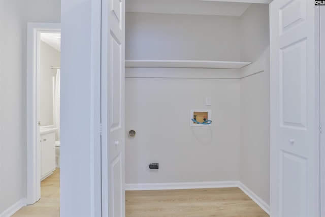 clothes washing area featuring baseboards, washer hookup, laundry area, light wood-style floors, and electric dryer hookup