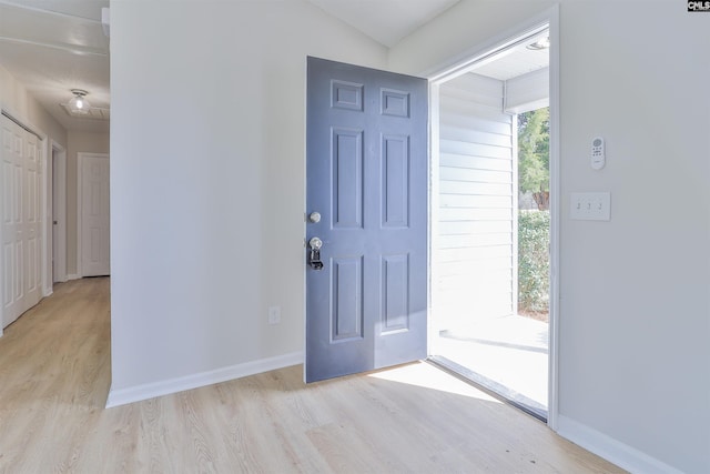 entrance foyer featuring baseboards and light wood-style flooring