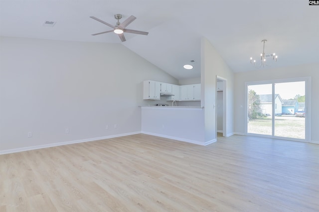 unfurnished living room with visible vents, lofted ceiling, light wood-style flooring, ceiling fan with notable chandelier, and baseboards