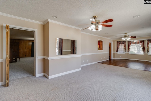 unfurnished living room featuring a textured ceiling, carpet flooring, and ornamental molding