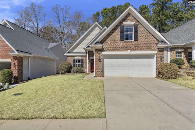 view of front facade featuring brick siding, a garage, driveway, and a front lawn