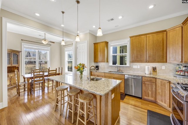 kitchen featuring a sink, appliances with stainless steel finishes, and light wood-style flooring