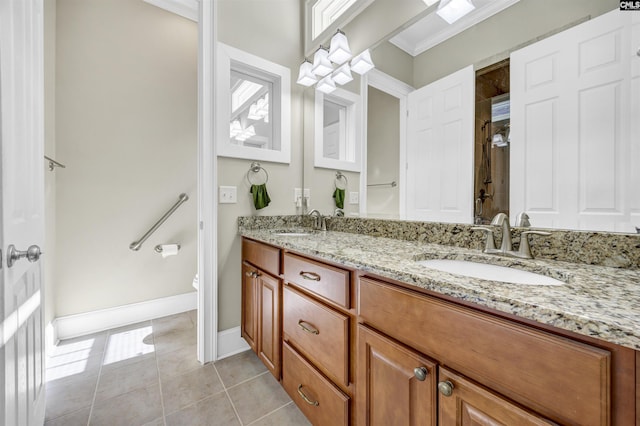 full bathroom with tile patterned flooring, crown molding, toilet, double vanity, and a sink