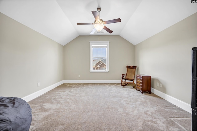 living area with lofted ceiling, baseboards, carpet floors, and ceiling fan