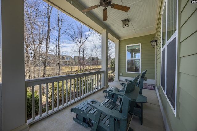 balcony with a porch and ceiling fan