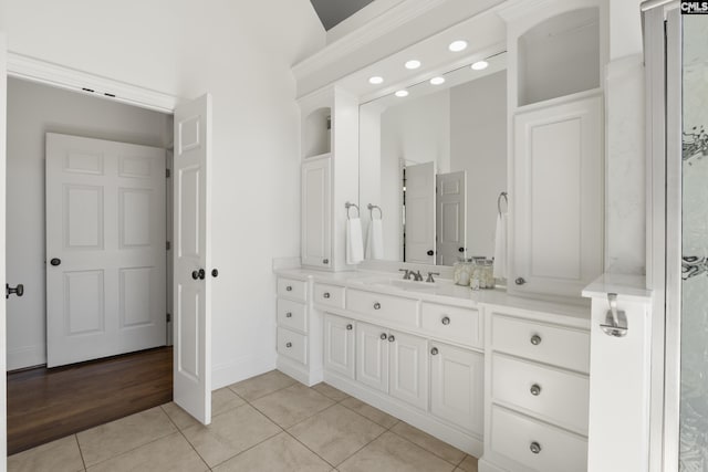 bathroom featuring vanity, tile patterned floors, and baseboards