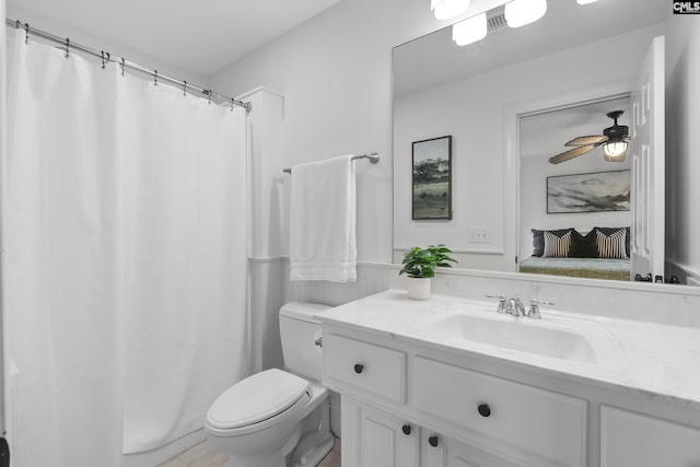 full bathroom with vanity, a shower with curtain, ceiling fan, toilet, and connected bathroom