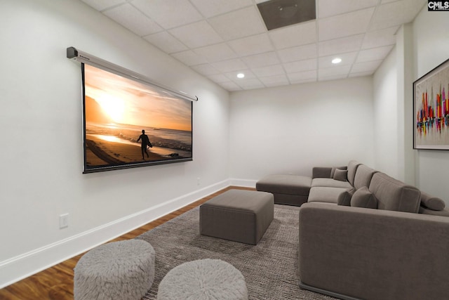 interior space featuring recessed lighting, a paneled ceiling, baseboards, and wood finished floors