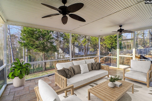 sunroom featuring ceiling fan