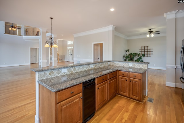 kitchen featuring ornate columns, ornamental molding, light wood-style floors, ceiling fan with notable chandelier, and open floor plan