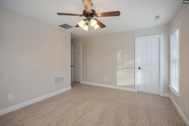 unfurnished bedroom with visible vents, baseboards, and light colored carpet