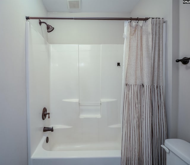 bathroom with shower / tub combo, toilet, and visible vents