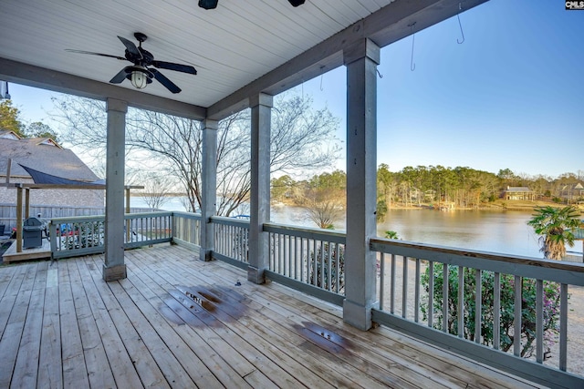 deck featuring a water view and ceiling fan