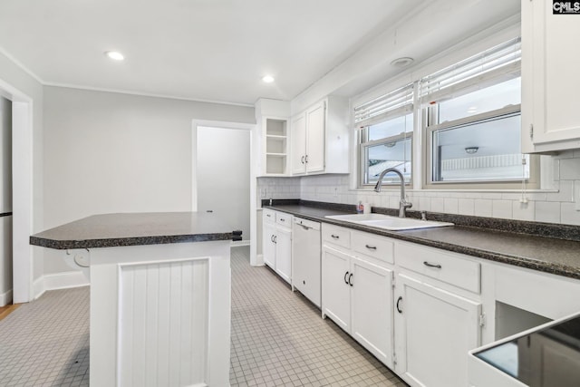 kitchen with a sink, open shelves, dark countertops, and dishwasher