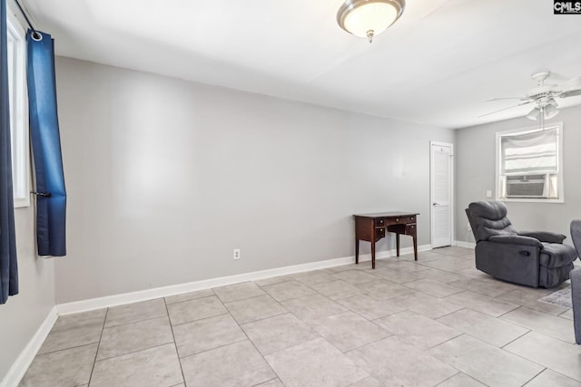 sitting room featuring light tile patterned floors, ceiling fan, cooling unit, and baseboards