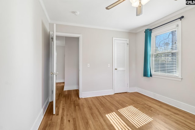 unfurnished bedroom featuring baseboards, ornamental molding, and light wood finished floors