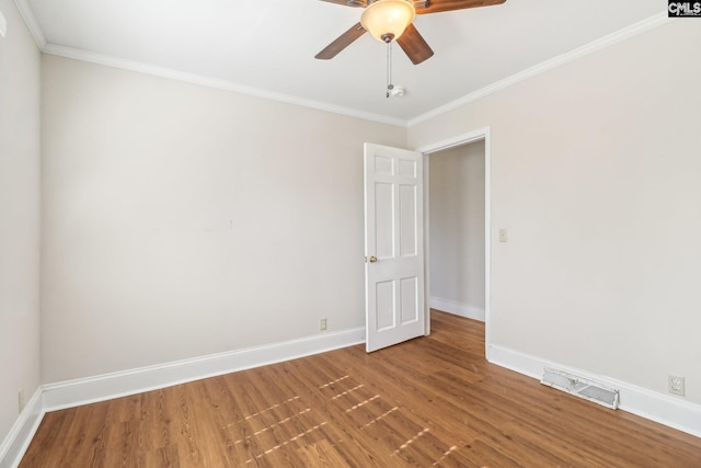 unfurnished room with baseboards, wood finished floors, visible vents, and ceiling fan