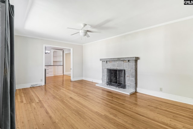 unfurnished living room with baseboards, a ceiling fan, light wood-style floors, and ornamental molding