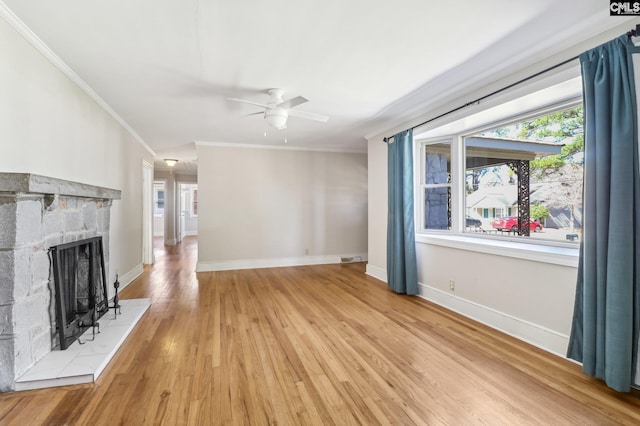 unfurnished living room featuring light wood-style flooring, baseboards, ceiling fan, and crown molding