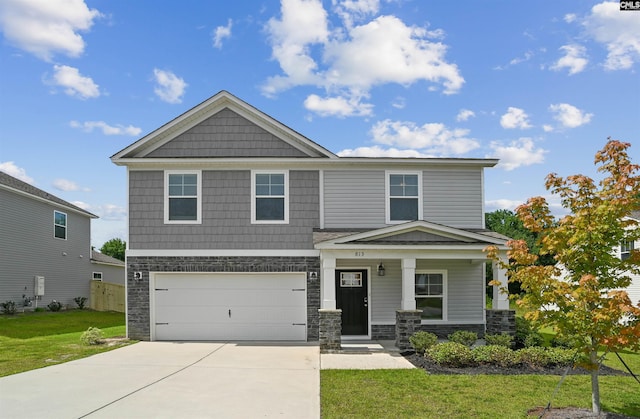 craftsman-style home featuring a front lawn, a porch, driveway, stone siding, and an attached garage