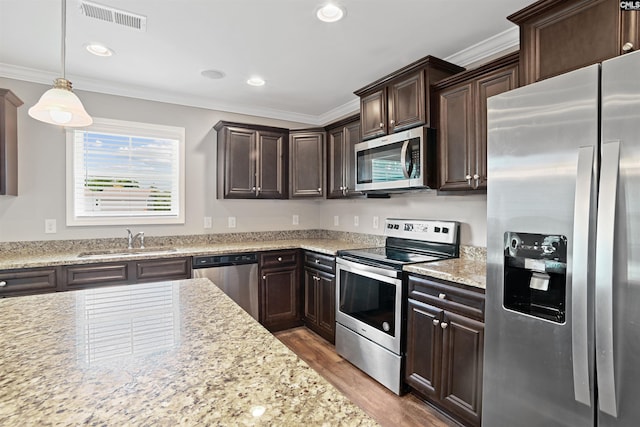 kitchen with visible vents, dark brown cabinetry, light wood-type flooring, stainless steel appliances, and a sink