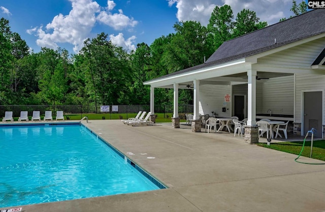 pool featuring a patio, a ceiling fan, and fence