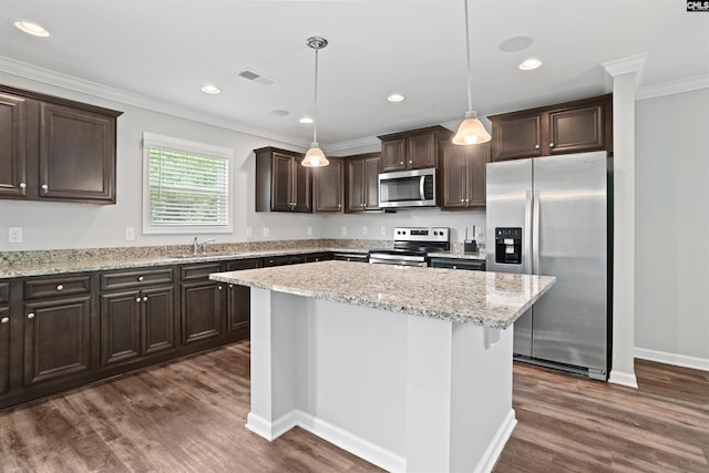 kitchen featuring visible vents, ornamental molding, stainless steel appliances, dark brown cabinets, and dark wood-style flooring