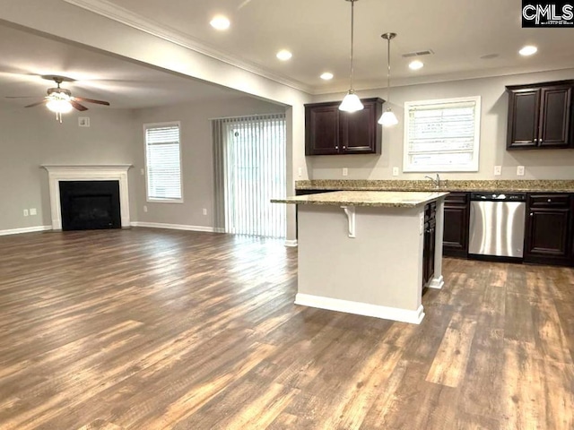 kitchen featuring stainless steel dishwasher, dark brown cabinets, a breakfast bar, and a ceiling fan