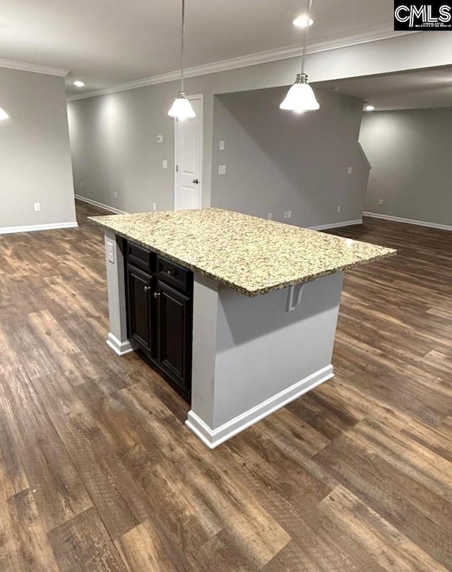 kitchen with dark wood-type flooring, baseboards, open floor plan, and a center island