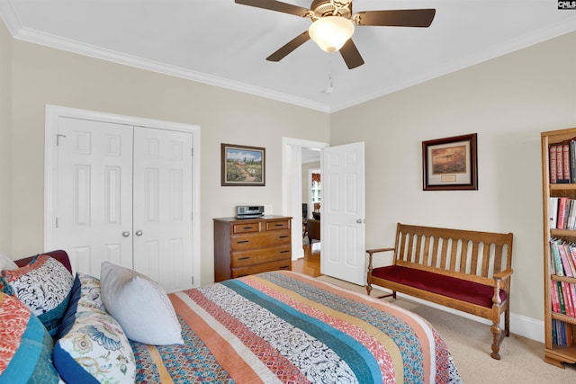 bedroom featuring light carpet, ceiling fan, a closet, and ornamental molding