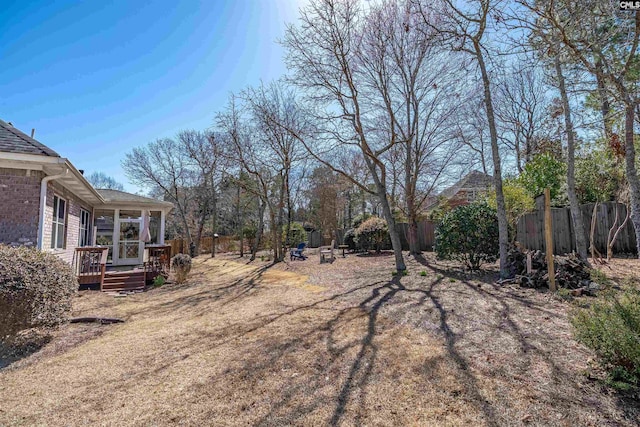 view of yard with a wooden deck and fence