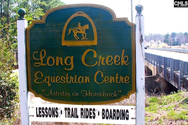 community sign featuring fence