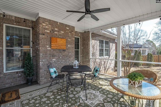 view of patio / terrace with outdoor dining space, fence, and ceiling fan