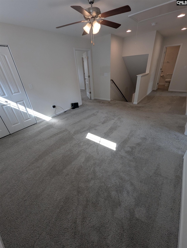 unfurnished living room with recessed lighting, light colored carpet, attic access, and ceiling fan