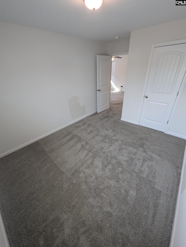 unfurnished bedroom with baseboards and carpet