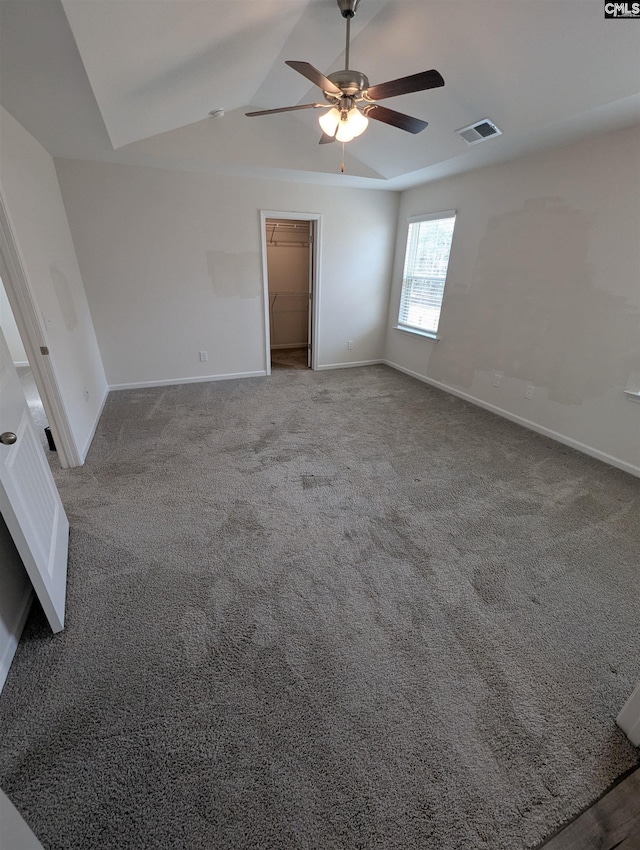 spare room with a ceiling fan, visible vents, and baseboards