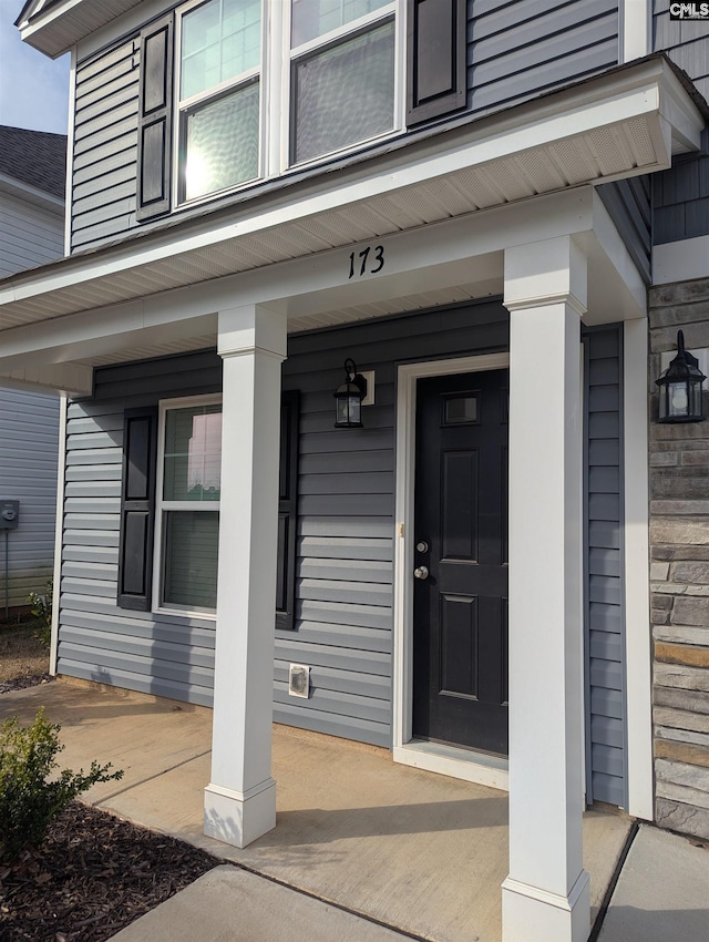 doorway to property featuring covered porch