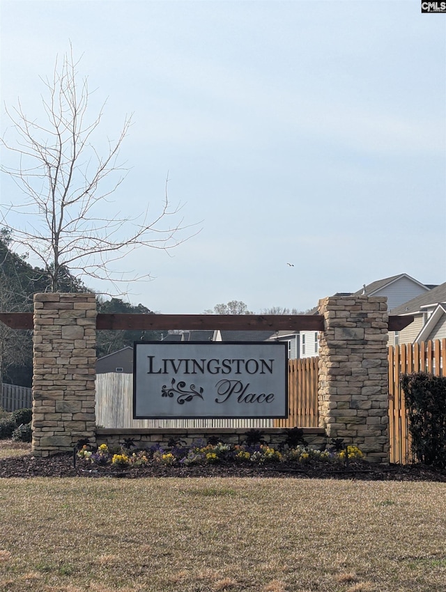 community sign featuring fence