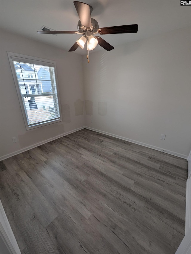 unfurnished room with wood finished floors, baseboards, and ceiling fan