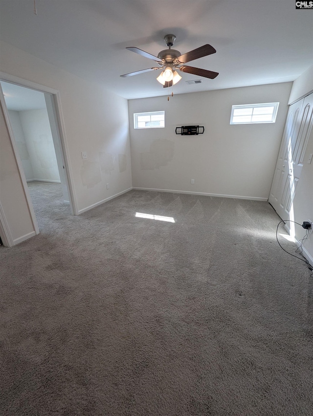 interior space featuring visible vents, plenty of natural light, baseboards, and a ceiling fan