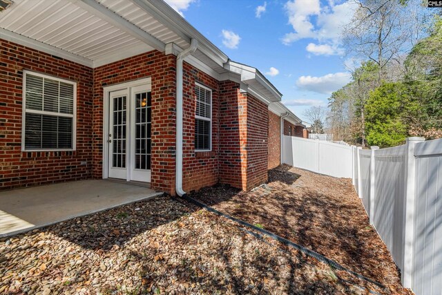 141 Vista Oaks Dr, Lexington, SC 29072 - exterior space with a patio, a fenced backyard, and brick siding