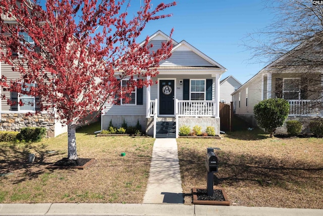 view of front of house with a porch and a front lawn