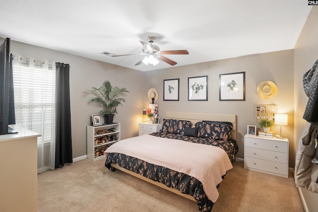 carpeted bedroom with baseboards and a ceiling fan