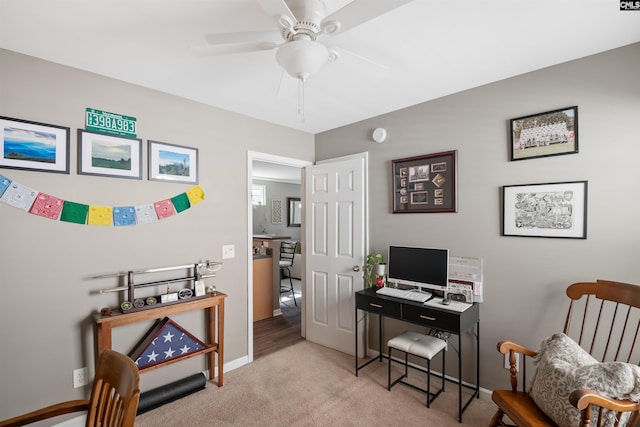 home office with carpet flooring, baseboards, and a ceiling fan