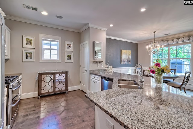 kitchen with a wealth of natural light, visible vents, ornamental molding, a sink, and appliances with stainless steel finishes