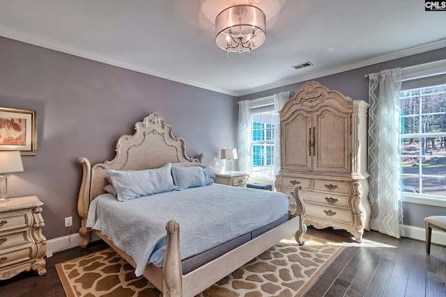 bedroom with crown molding, baseboards, visible vents, and dark wood-style flooring