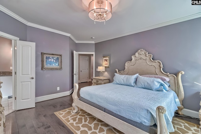 bedroom featuring crown molding, baseboards, and wood finished floors